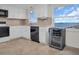 Modern kitchen with white cabinets, black appliances and water views at 9 Haig Pl # 612, Dunedin, FL 34698