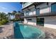 Modern freeform pool with paver deck and water feature at 12400 Capri N Cir # A, Treasure Island, FL 33706