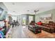 Spacious living room with leather furniture and wood-look floors at 5228 New Friendship Pl, Tampa, FL 33619
