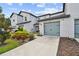 Modern townhouse with a light gray garage door and landscaping at 5228 New Friendship Pl, Tampa, FL 33619
