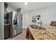 Stainless steel refrigerator and granite countertop kitchen at 5228 New Friendship Pl, Tampa, FL 33619