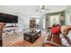 Spacious living room featuring a comfortable leather sofa and a large TV at 5228 New Friendship Pl, Tampa, FL 33619