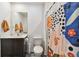 Bathroom with toilet, sink, and patterned shower curtain at 5228 New Friendship Pl, Tampa, FL 33619