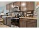 Modern kitchen with dark brown cabinets and granite countertops at 5228 New Friendship Pl, Tampa, FL 33619