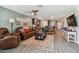 Open living area with leather couch and large TV at 5228 New Friendship Pl, Tampa, FL 33619
