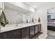Double vanity bathroom with a large mirror and access to bedroom at 5228 New Friendship Pl, Tampa, FL 33619