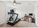 Bright home gym with treadmill, exercise bike and desk at 5228 New Friendship Pl, Tampa, FL 33619