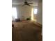 Spacious living room with ceiling fan and large carpeted area at 6100 12Th S St # 211, St Petersburg, FL 33705