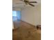 Living room with ceiling fan, sliding glass doors, and stained carpet at 6100 12Th S St # 211, St Petersburg, FL 33705