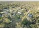 Wider aerial view showing property, neighborhood, and surrounding trees at 7809 Alafia Dr, Riverview, FL 33578