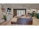 Open concept living room and kitchen with a cozy sectional sofa and a large TV at 7809 Alafia Dr, Riverview, FL 33578