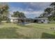 Large backyard with screened pool and grassy area at 7809 Alafia Dr, Riverview, FL 33578