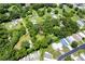 An aerial view of a property surrounded by dense trees and neighboring homes at 37427 Southside Dr, Zephyrhills, FL 33541