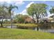 Scenic backyard featuring water views, lush greenery, and mature trees, creating a serene outdoor space at 6816 Dali Ave # 101, Land O Lakes, FL 34637