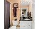 Clean bathroom with white vanity, black countertop, and a framed mirror at 6816 Dali Ave # 101, Land O Lakes, FL 34637