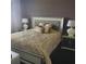 Serene main bedroom with decorative bedding, modern bedside lamps, and stylish decor at 6816 Dali Ave # 101, Land O Lakes, FL 34637