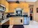 The kitchen showcases stainless steel appliances, sleek black countertops, and ample cabinet space at 6816 Dali Ave # 101, Land O Lakes, FL 34637