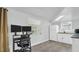 Small galley kitchen with white cabinets and granite countertops at 9406 Rainbow Ln, Port Richey, FL 34668