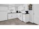 Bright eat-in kitchen, featuring white cabinetry, granite countertops, and modern appliances at 9406 Rainbow Ln, Port Richey, FL 34668