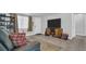 Living area showcasing a comfy couch, media console, and a neutral color palette at 9406 Rainbow Ln, Port Richey, FL 34668