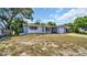 One-story home with gray siding, attached garage, and a spacious lawn at 9406 Rainbow Ln, Port Richey, FL 34668