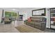 Living room featuring a sectional sofa, dining area, and built-in shelving at 9406 Rainbow Ln, Port Richey, FL 34668