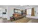 Living room with a gray sectional, a bookcase and a view of the kitchen at 9406 Rainbow Ln, Port Richey, FL 34668
