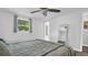 Bright bedroom with ceiling fan, full-size bed, and access to exterior at 9406 Rainbow Ln, Port Richey, FL 34668