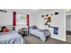 Two twin beds, a fish tank, and built-in shelves in this well-lit bedroom at 9406 Rainbow Ln, Port Richey, FL 34668