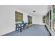 Screened porch with table and chairs, perfect for relaxing at 9406 Rainbow Ln, Port Richey, FL 34668