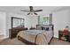 Primary bedroom with ceiling fan, full-size bed, and dresser with mirror at 9406 Rainbow Ln, Port Richey, FL 34668
