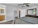 Primary bedroom with ceiling fan, full-size bed, and walk-in closet at 9406 Rainbow Ln, Port Richey, FL 34668
