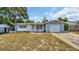 One-story home with gray block exterior and attached garage at 9406 Rainbow Ln, Port Richey, FL 34668