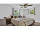 Spacious bedroom with ceiling fan, large bed, and ample natural light at 9406 Rainbow Ln, Port Richey, FL 34668