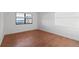 Bedroom with wood flooring and large window at 2539 Gary Cir # 603, Dunedin, FL 34698
