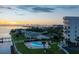 Aerial view of waterfront property with pool and building at sunset at 2539 Gary Cir # 603, Dunedin, FL 34698