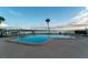 Community pool with water views and lounge chairs at 2539 Gary Cir # 603, Dunedin, FL 34698