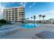 Community pool with lounge chairs and building view at 2539 Gary Cir # 603, Dunedin, FL 34698