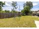 Large grassy backyard with play structure and wooden fence at 2551 15Th N Ave, St Petersburg, FL 33713