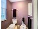 Small bathroom with toilet, bidet, and window for natural light at 6816 Dali Ave # 101, Land O Lakes, FL 34637