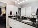 Double vanity bathroom with granite countertop and ample storage at 6816 Dali Ave # 101, Land O Lakes, FL 34637