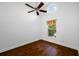 Simple bedroom with hardwood floors and ceiling fan at 1008 Blue Heron Way, Tarpon Springs, FL 34689