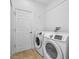 Laundry room with washer, dryer, and tile flooring at 1008 Blue Heron Way, Tarpon Springs, FL 34689