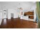 Open kitchen with hardwood floors, granite counters, and island at 1008 Blue Heron Way, Tarpon Springs, FL 34689