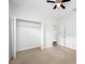 Bedroom with walk-in closet and ceiling fan at 1008 Blue Heron Way, Tarpon Springs, FL 34689