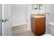 Small bathroom with granite vanity and toilet at 1008 Blue Heron Way, Tarpon Springs, FL 34689