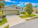 Charming single-Gathering home featuring a two-car garage, manicured lawn, and a well-maintained front yard at 1008 Blue Heron Way, Tarpon Springs, FL 34689