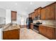 Modern kitchen with stainless steel appliances and wood cabinets at 1008 Blue Heron Way, Tarpon Springs, FL 34689