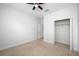 Spacious bedroom with ceiling fan, closet, and carpet flooring at 1008 Blue Heron Way, Tarpon Springs, FL 34689