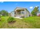 Home with deck, patio, and grassy backyard at 1008 Blue Heron Way, Tarpon Springs, FL 34689